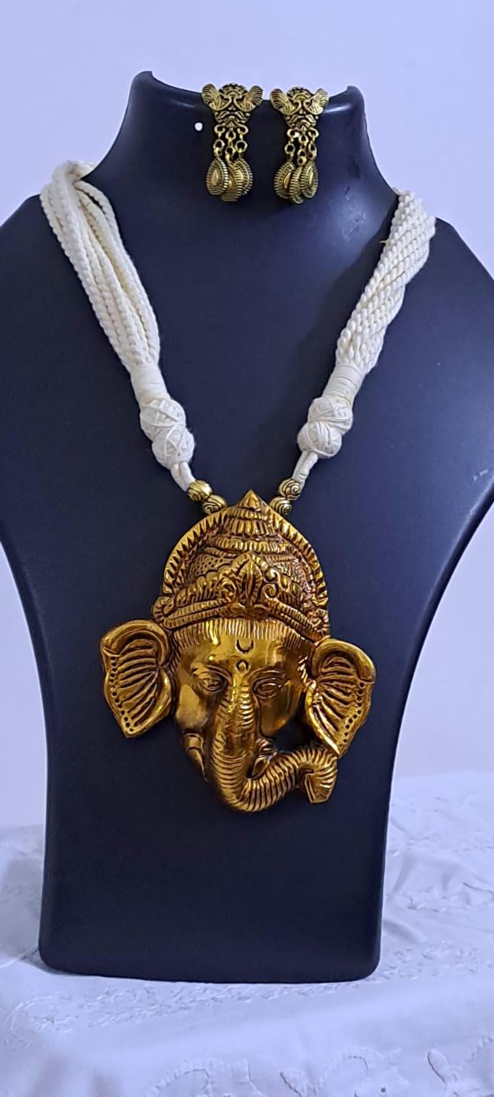 Off-white thread necklace with golden oxidised ganesha pendant