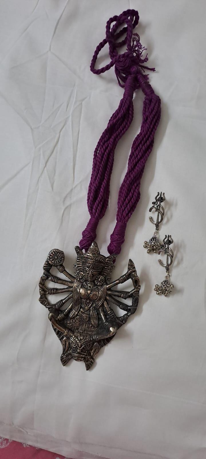 purple thread necklace with oxidised golden durga pendant