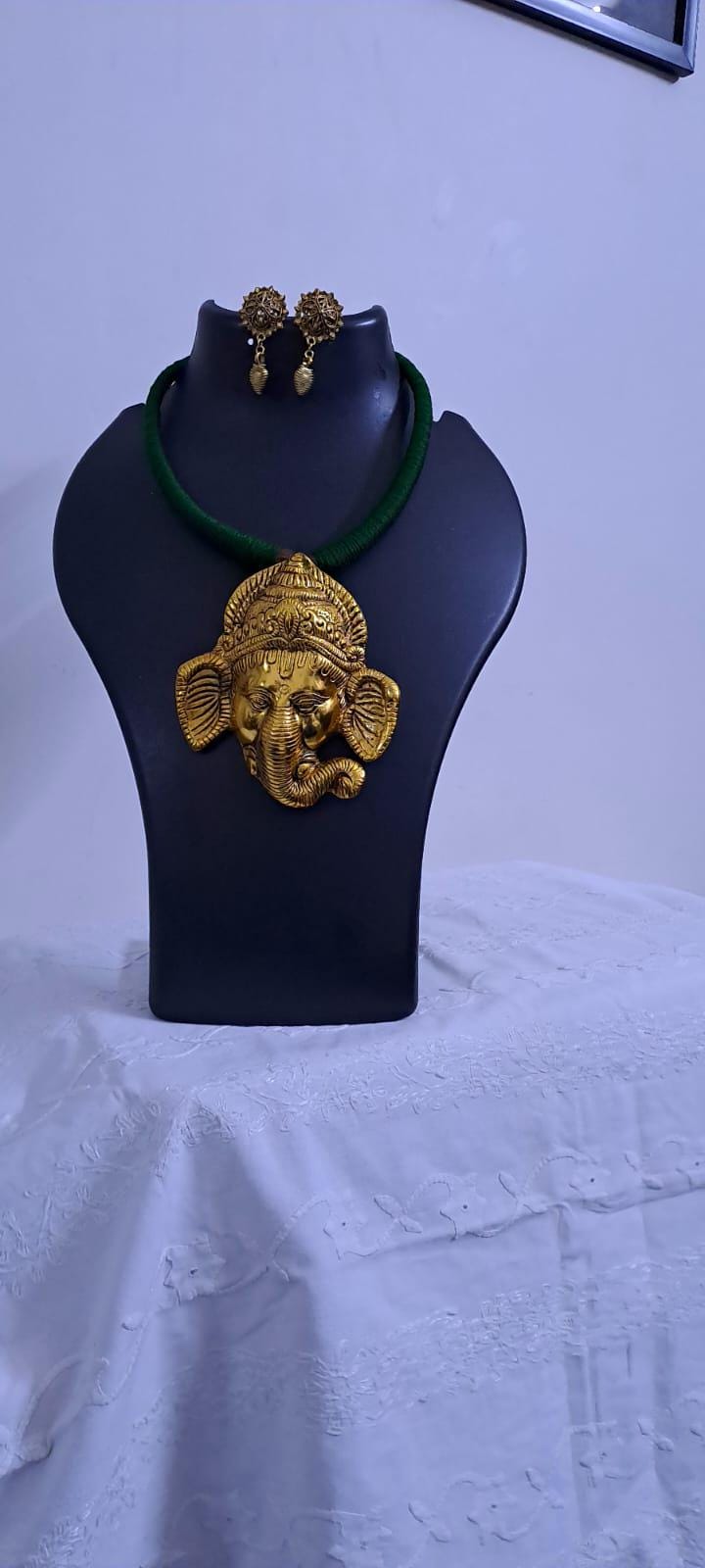 Green thread necklace with golden oxidised ganesha pendant