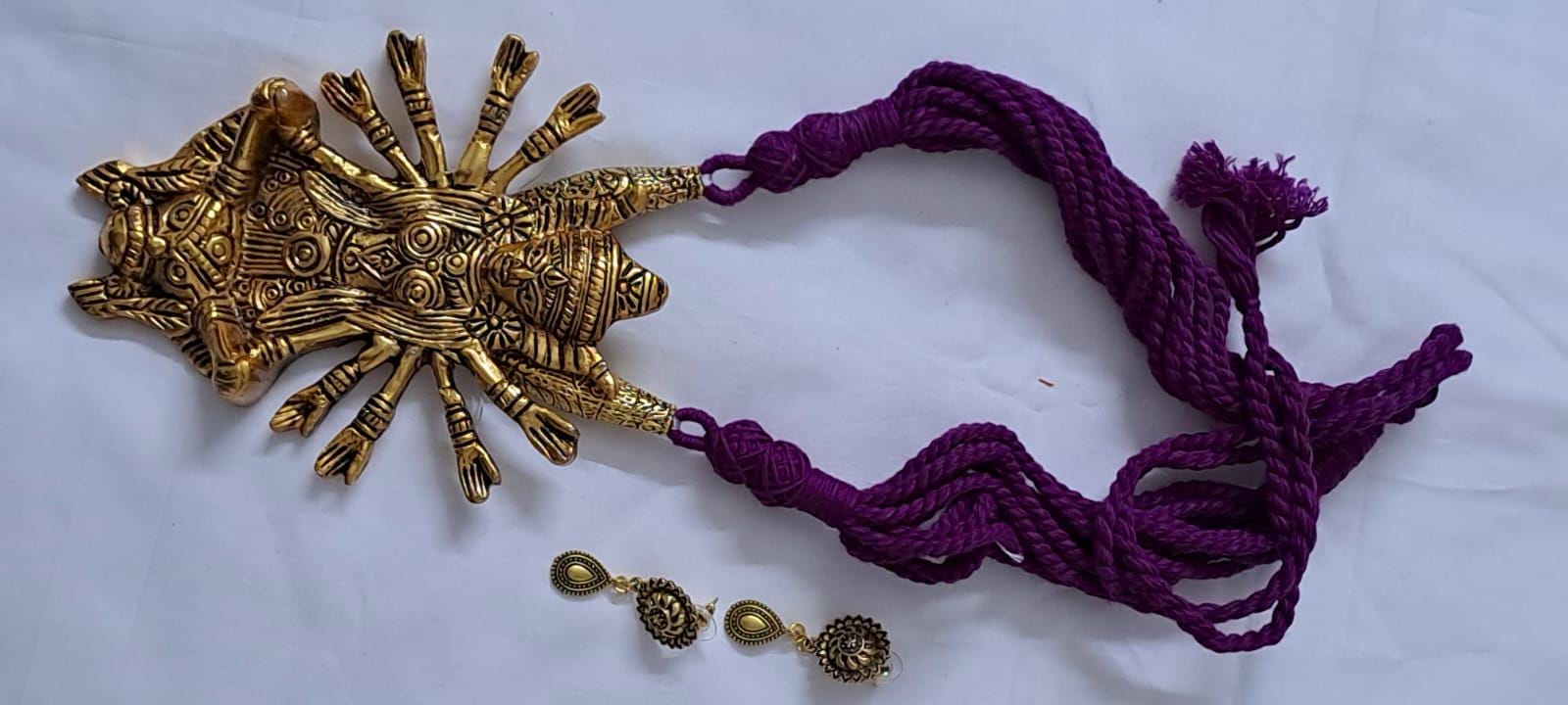Purple thread necklace with oxidised golden durga pendant