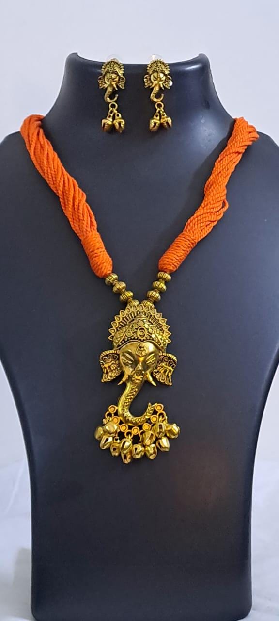 Orange thread necklace with Golden oxidised traditional pendant