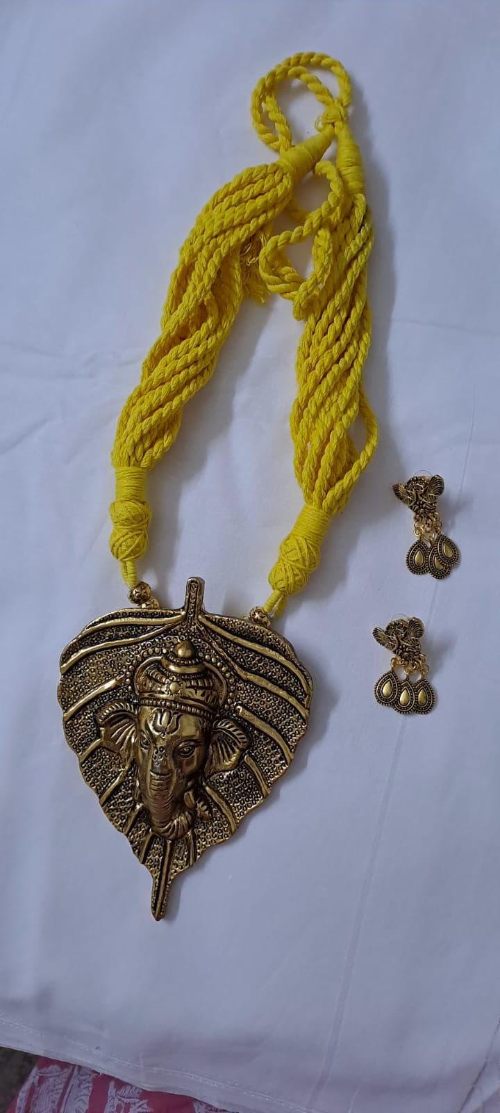 Yellow thread necklace with golden oxidised ganesha pendant