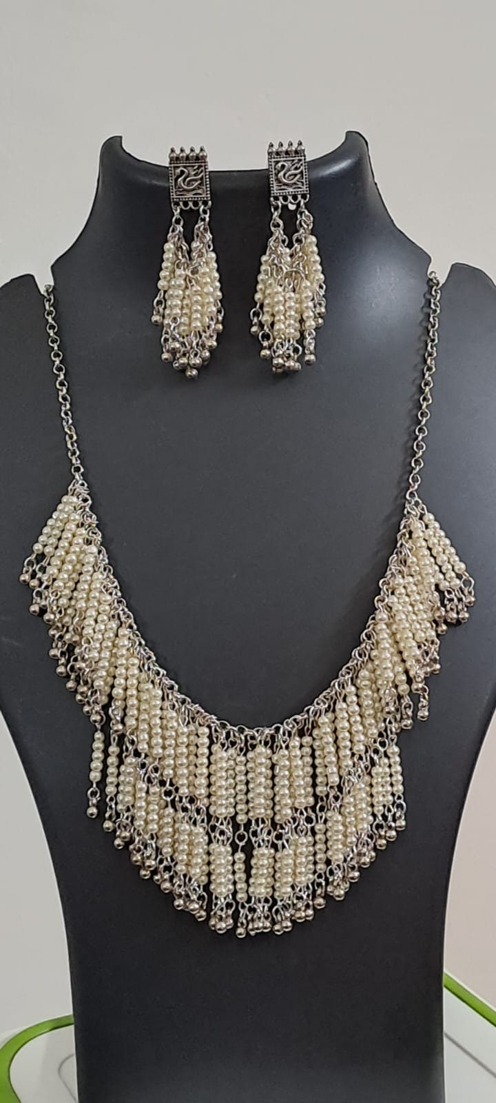 Exclusive layered off white seed beads necklace with matching hanging earrings.