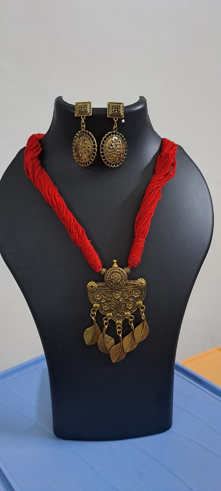 Red thread necklace with golden oxidised traditional pendant