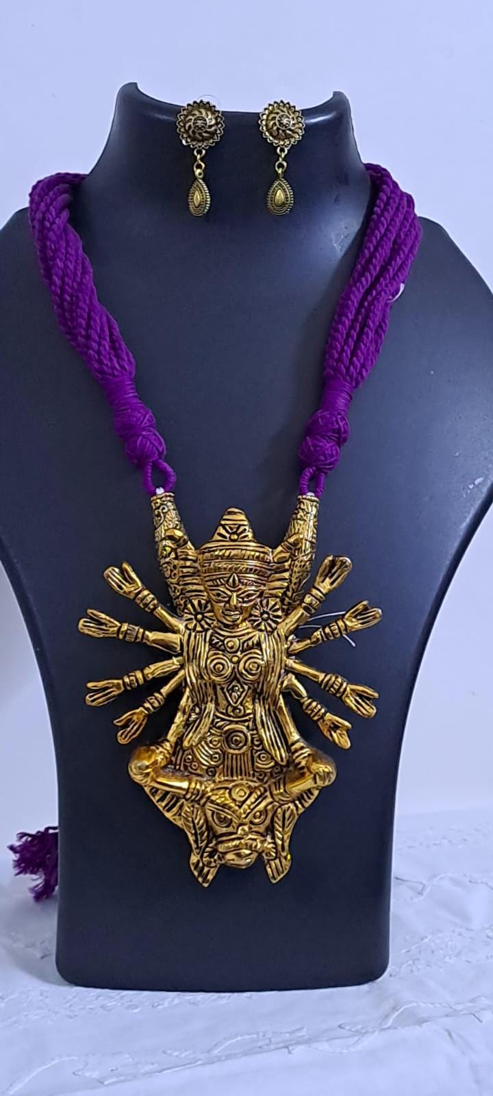 Purple thread necklace with oxidised golden durga pendant