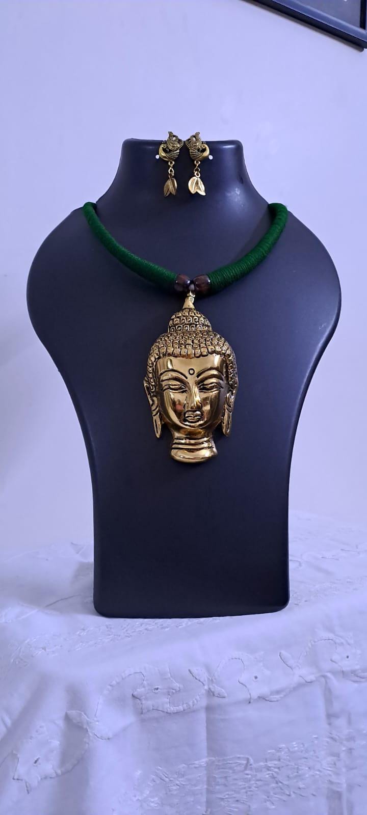 Green thread necklace with oxidised golden buddha pendant