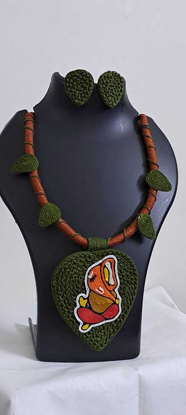 Exclusive forest green and brown thread necklace with leaf shaped  Ganesha thread pendant and matching earrings.