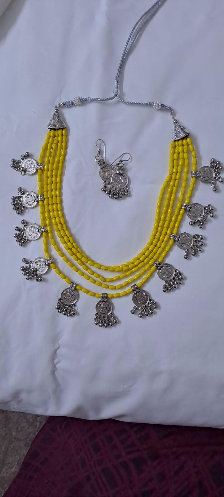 Exclusive multi layered  yellow glass beads necklace set with silver oxidised charms n matching earrings
