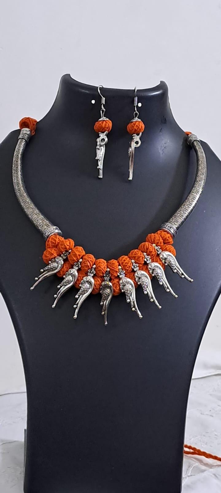 Orange thread necklace with kolhapuri silver oxidised traditional beads and matching earrings