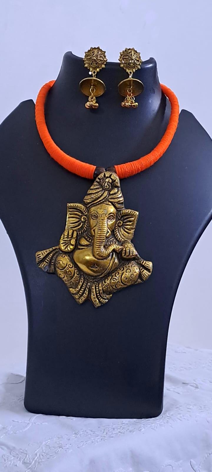 Orange thread necklace with golden oxidised ganesha pendant
