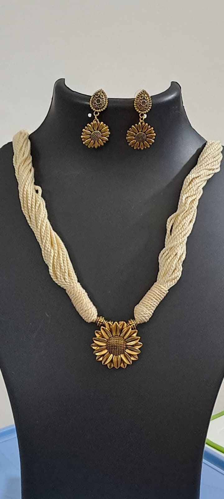 Off white thread necklace with oxidised silver sunflower pendant