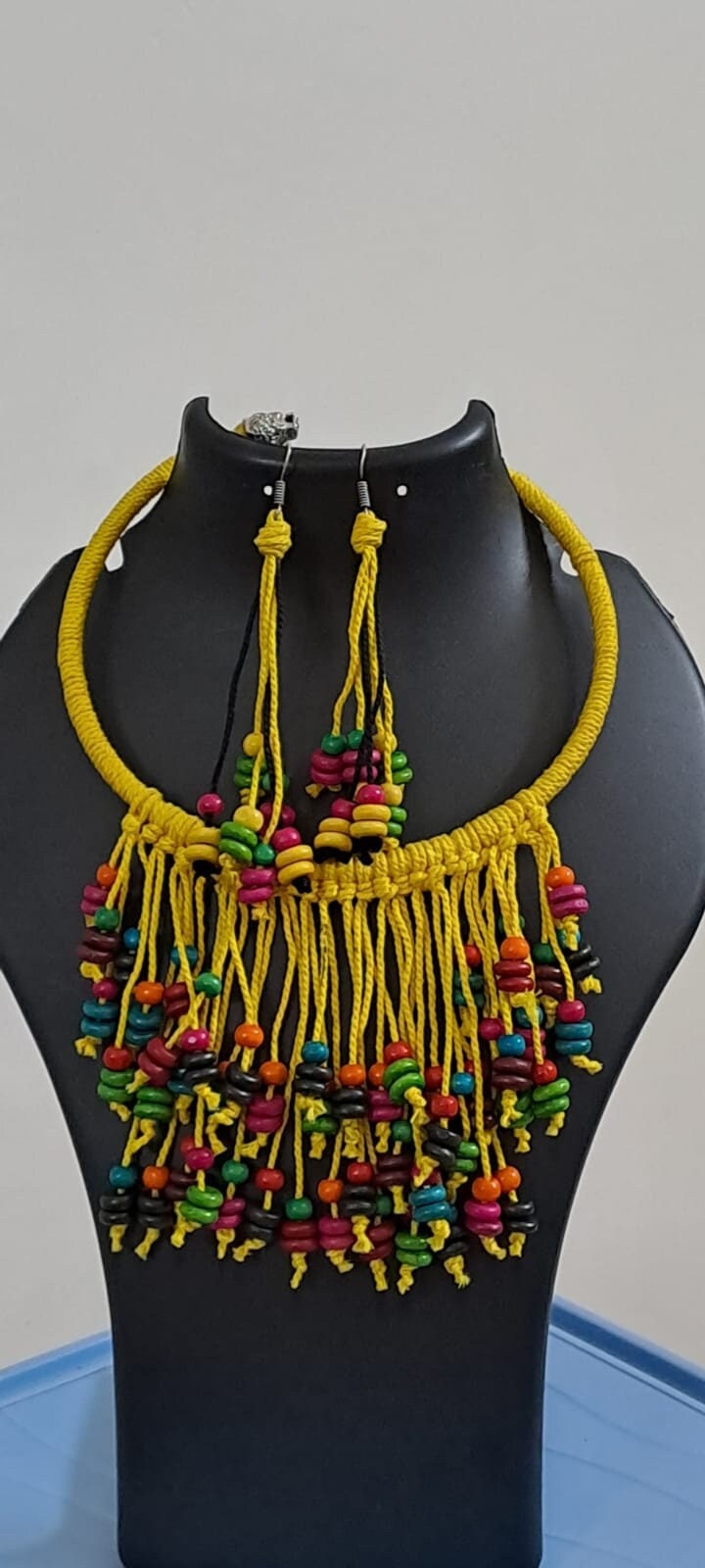 Exclusive yellow thread neckband with fringes and matching earrings.