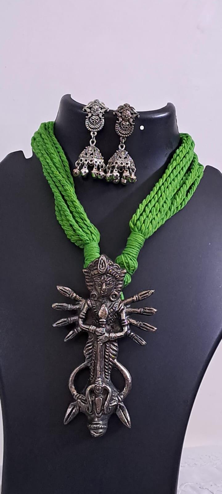 Green thread necklace with oxidised silver durga pendant