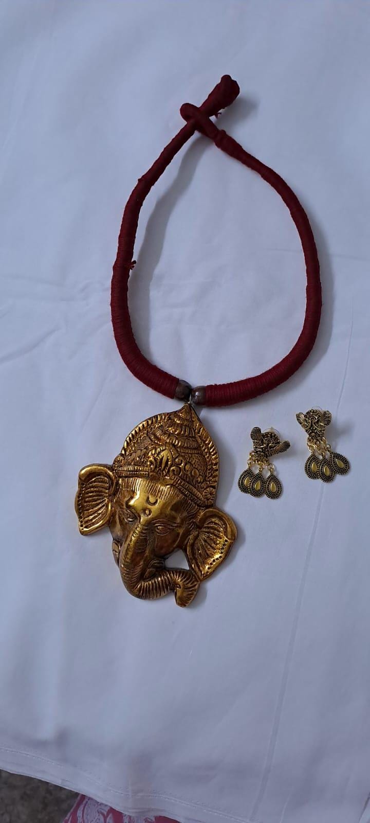 Maroon thread necklace with golden oxidised ganesha pendant