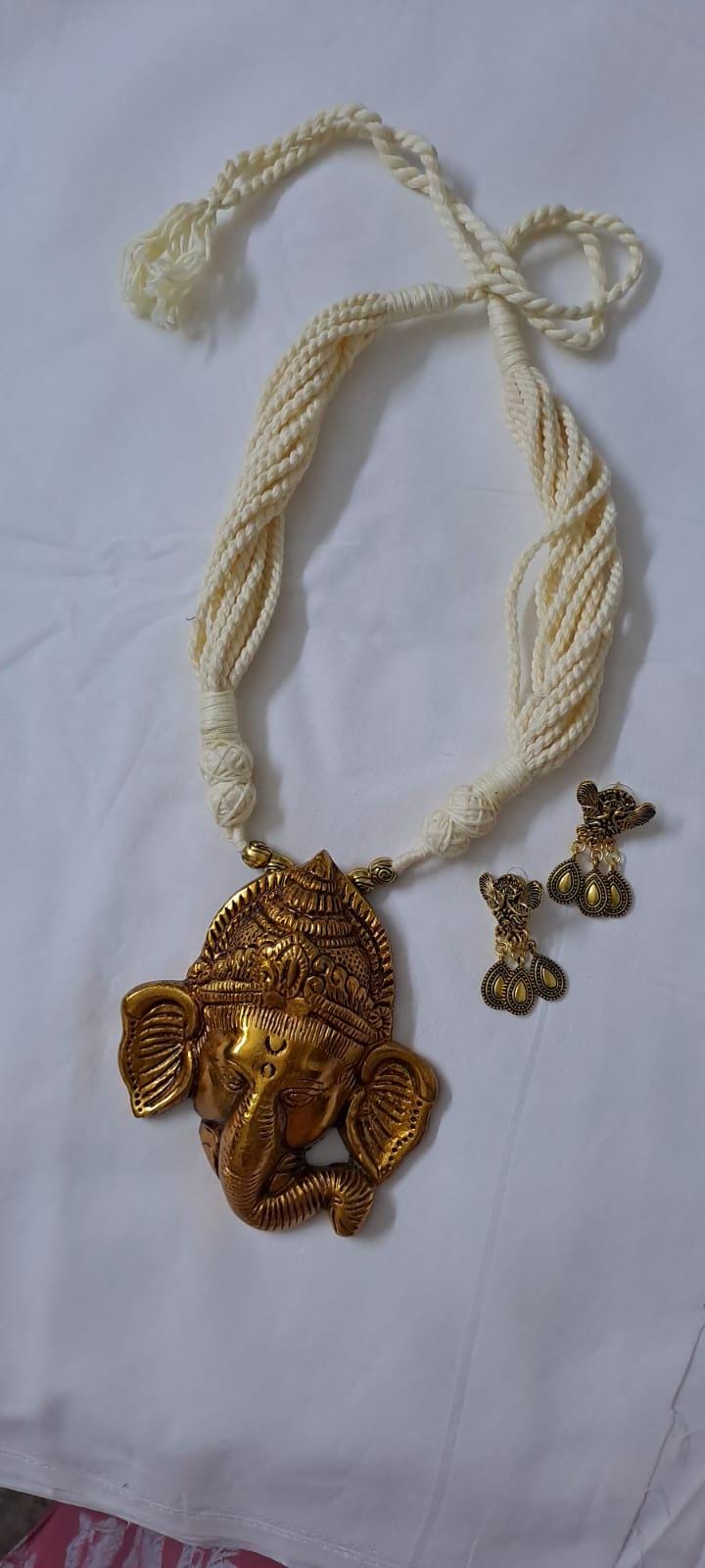 Off-white thread necklace with golden oxidised ganesha pendant