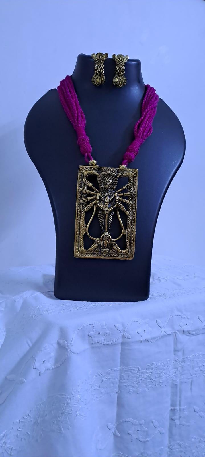 Pink thread necklace with oxidised golden durga pendant