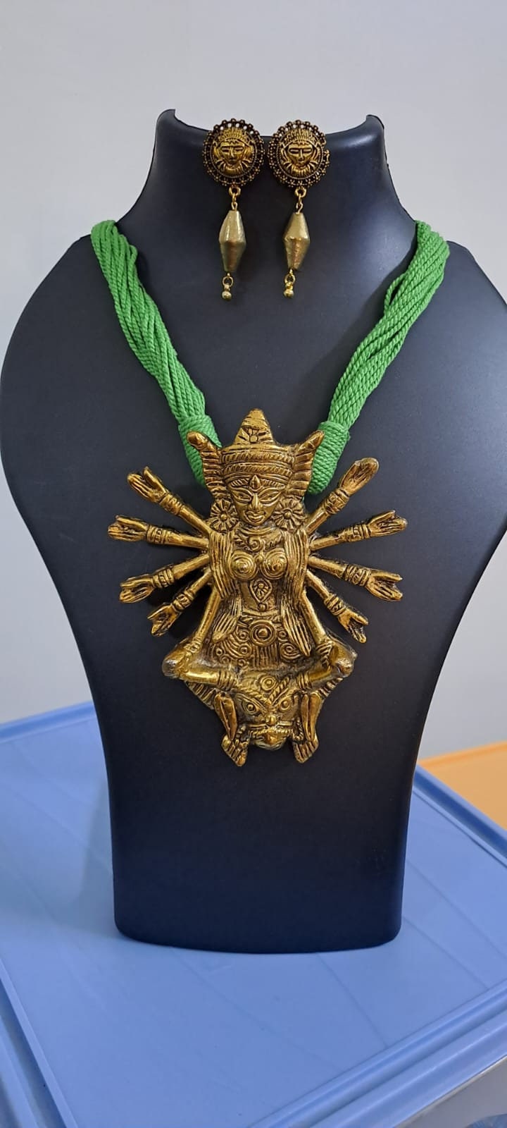 Green thread necklace with oxidised golden durga pendant