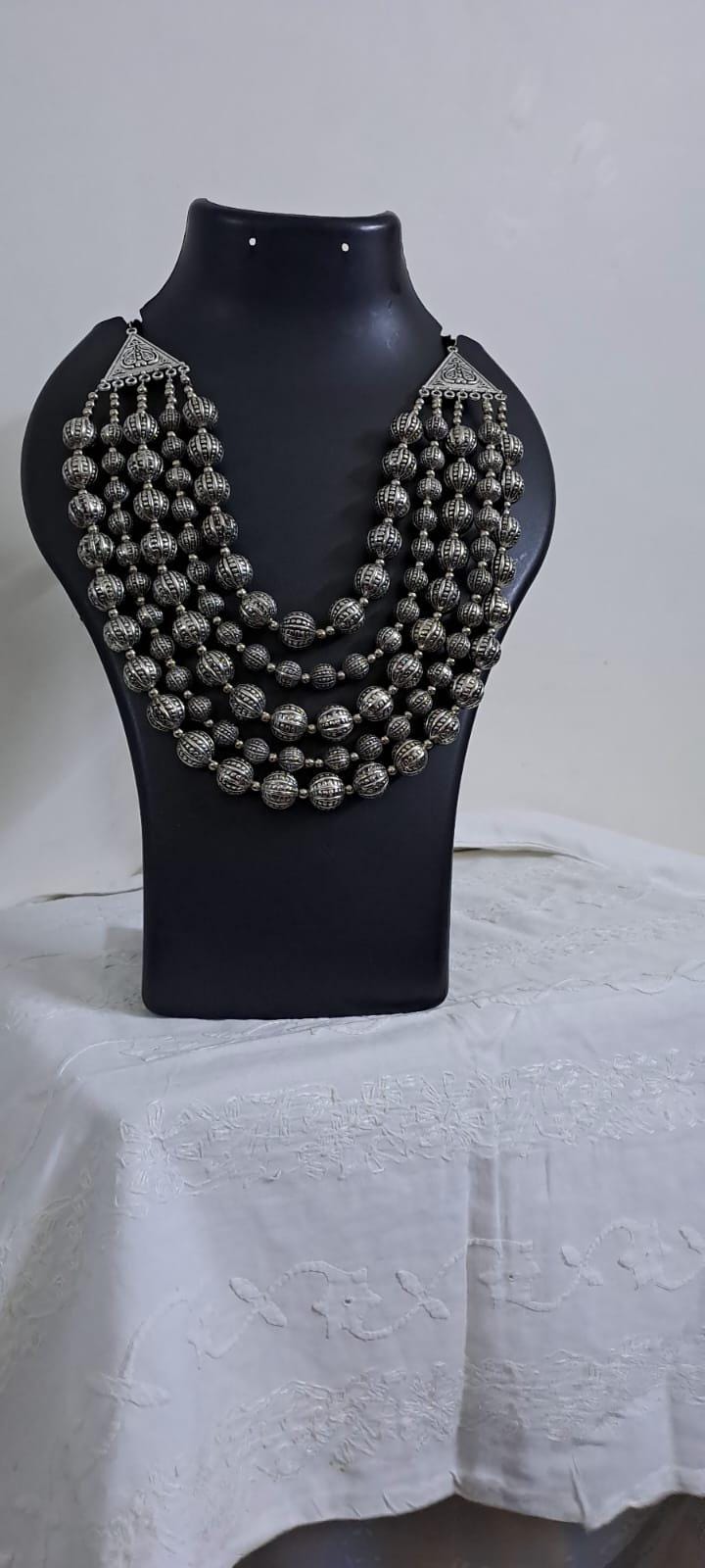 Multi-layered silver oxidised beads necklace .