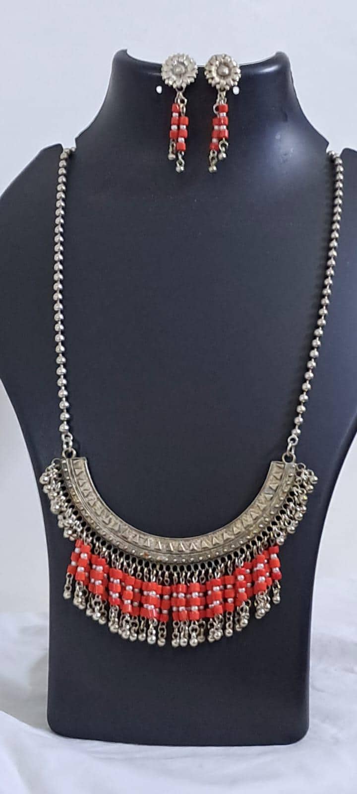 Exclusive necklace with silver oxidised big oval pendant with glass beads fringes and matching earrings.