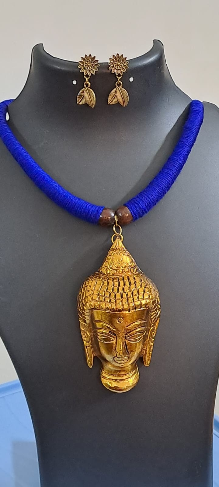 Blue thread necklace with golden oxidised buddha pendant