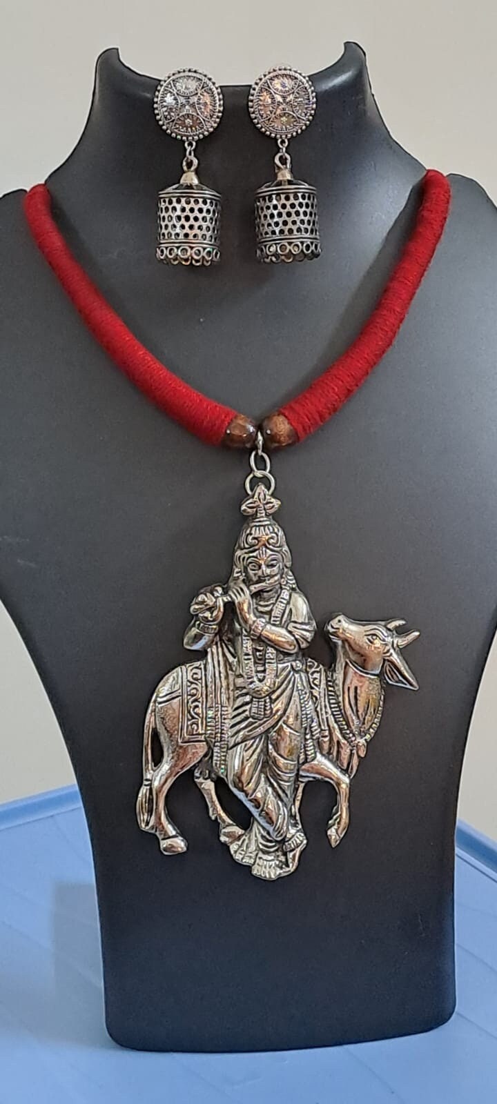 Red thread necklace with silver oxidised krishna pendant