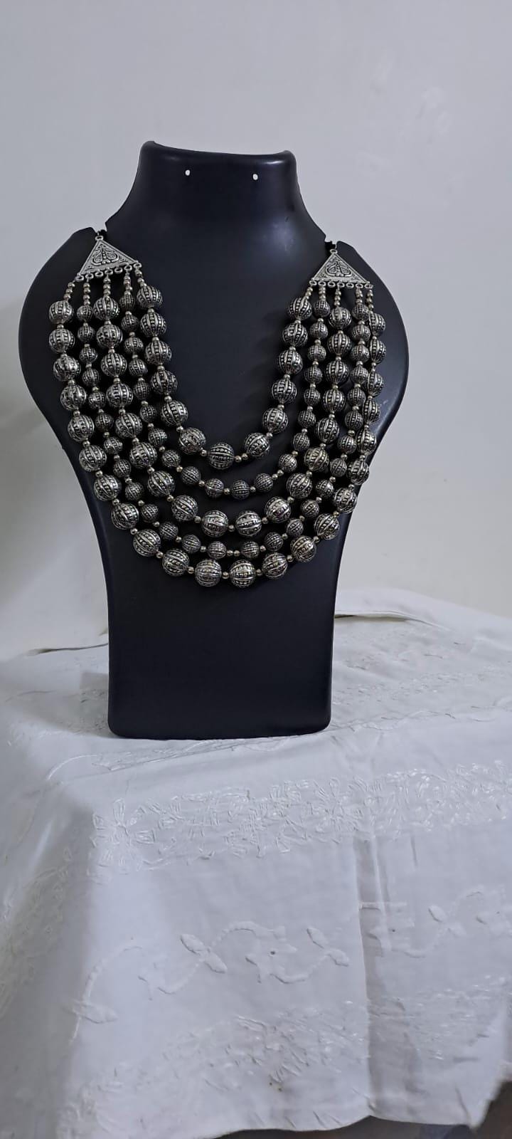 Multi-layered silver oxidised beads necklace .