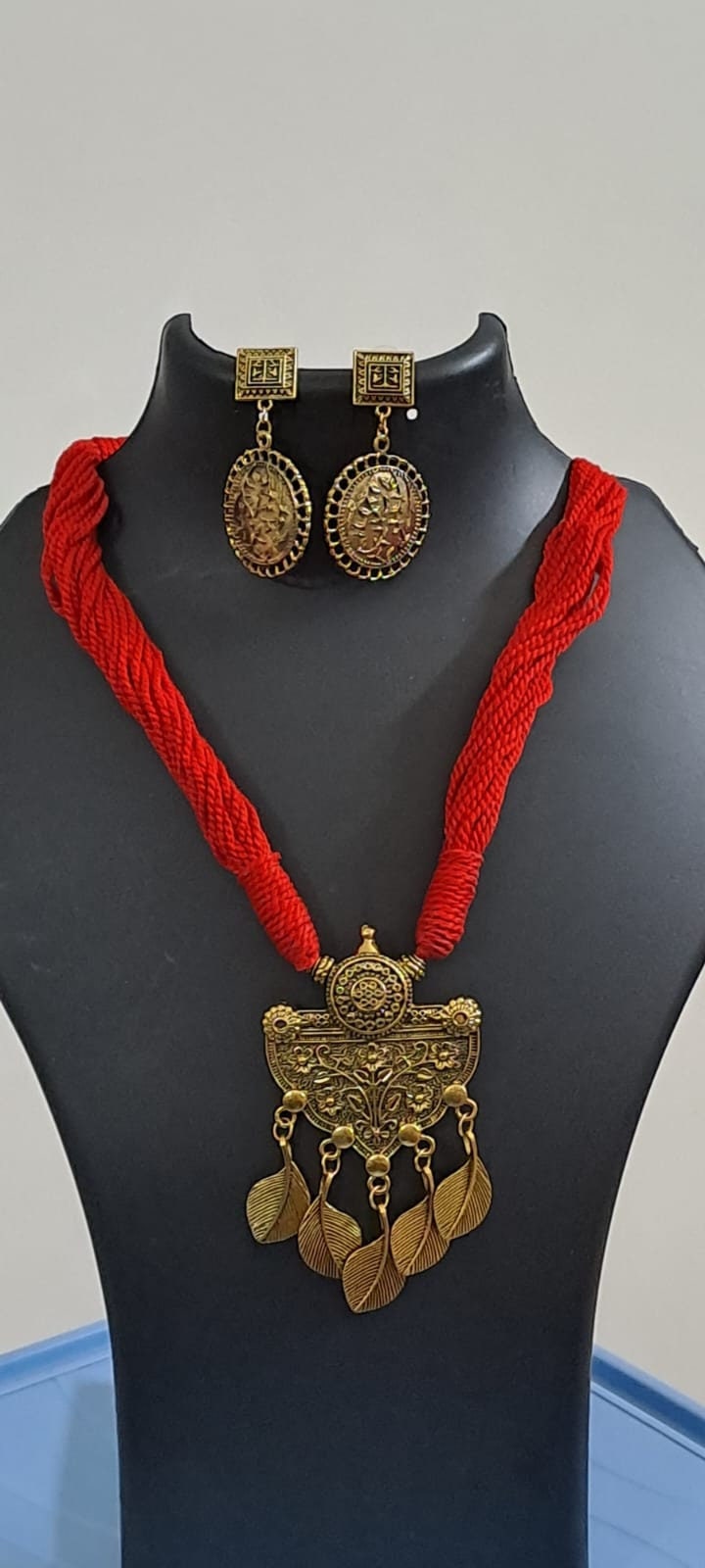 Red thread necklace with golden oxidised traditional pendant