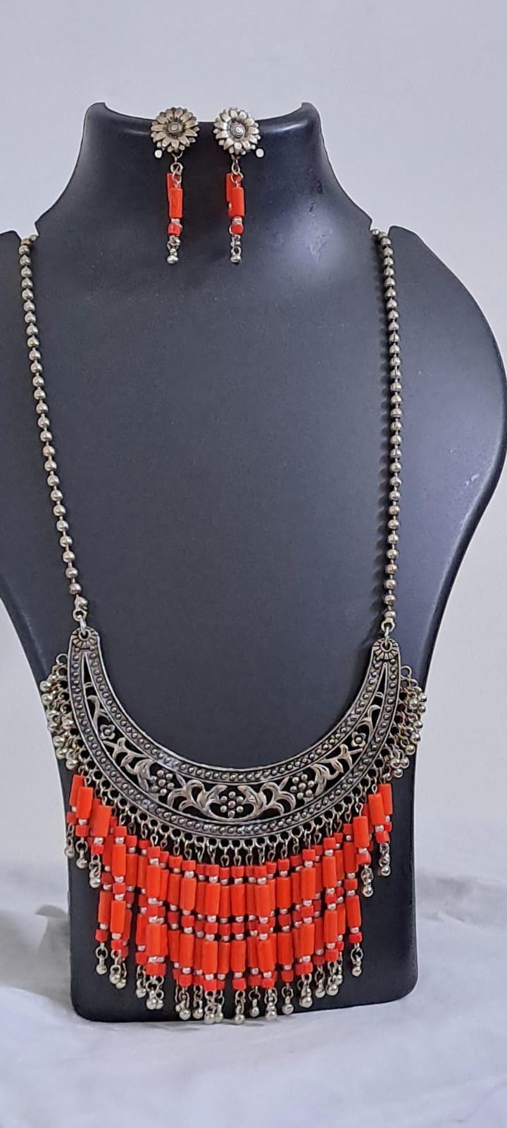 Exclusive necklace with silver oxidised big oval pendant with glass beads fringes and matching earrings.