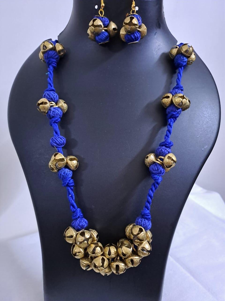 Blue thread necklace with trinkets n matching earrings