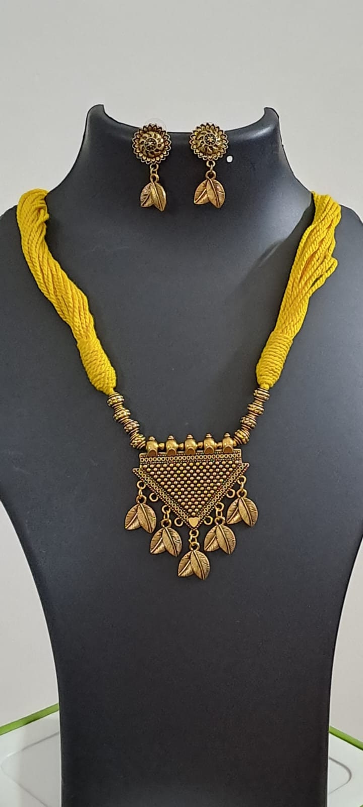 Yellow thread necklace with golden oxidised traditional pendant