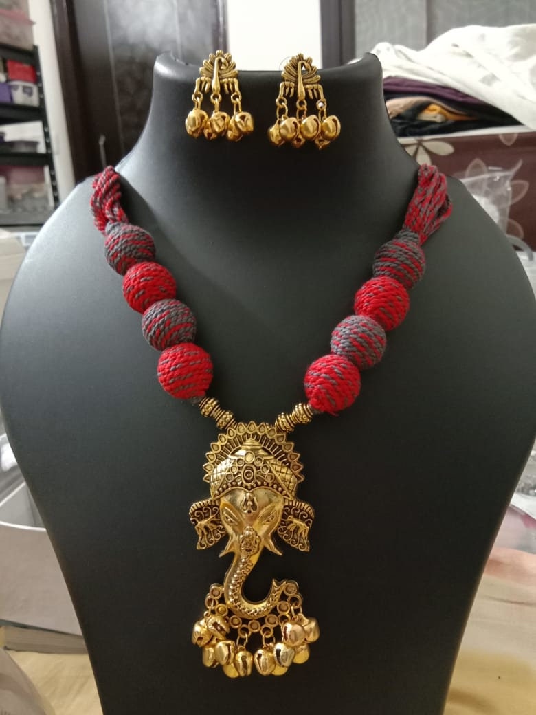Oxidised golden ganesha traditional pendant and matching earrings.