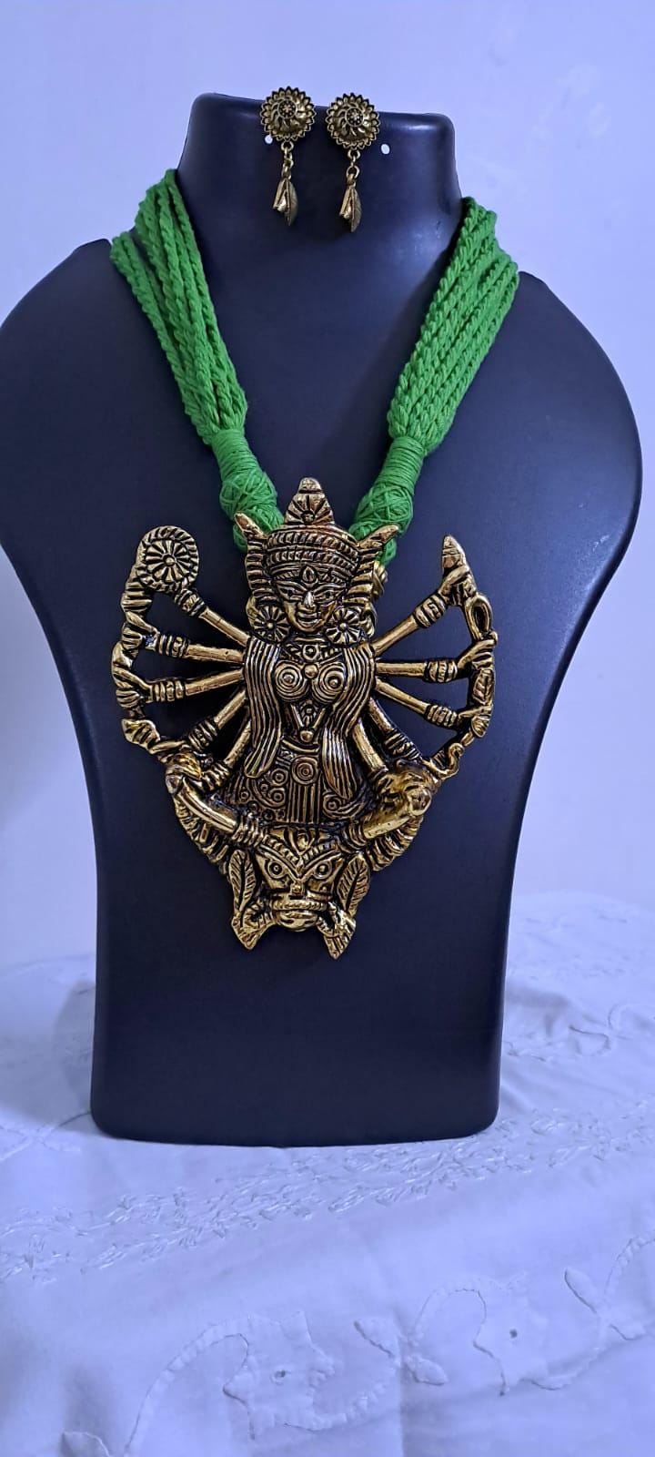 Green thread necklace with oxidised golden durga pendant
