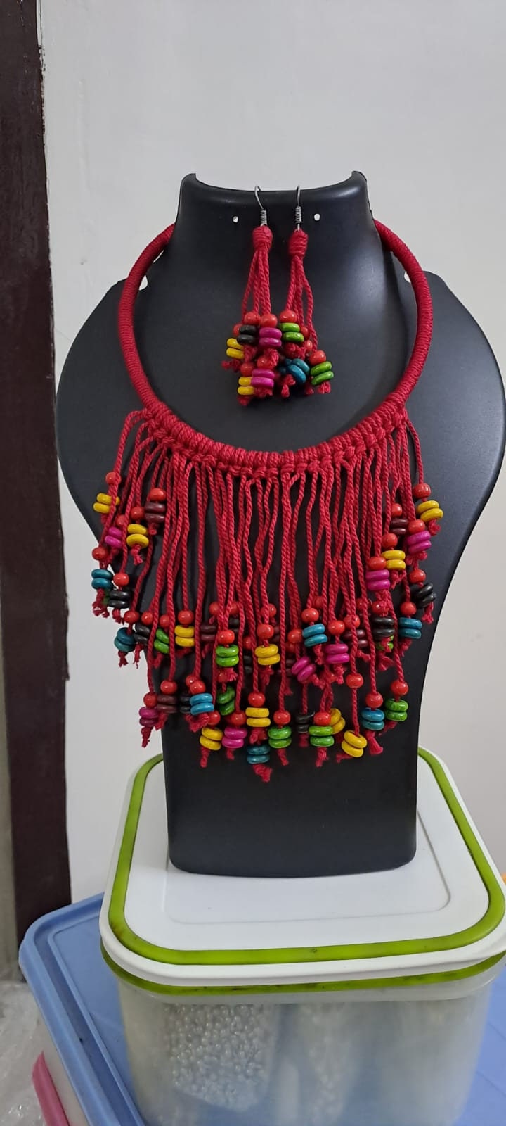Exclusive red thread neckband with fringes and matching earrings.