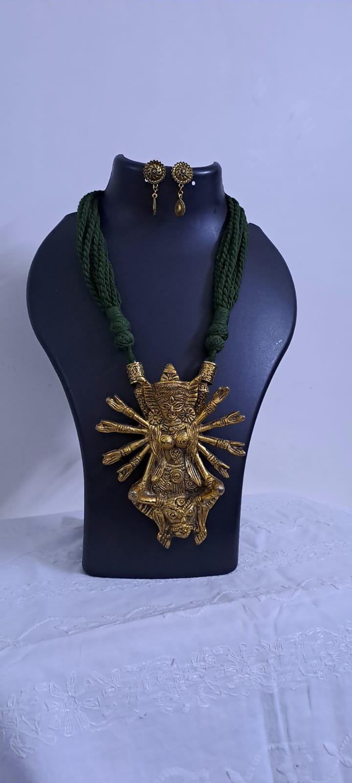 Green thread necklace with oxidised golden durga pendant