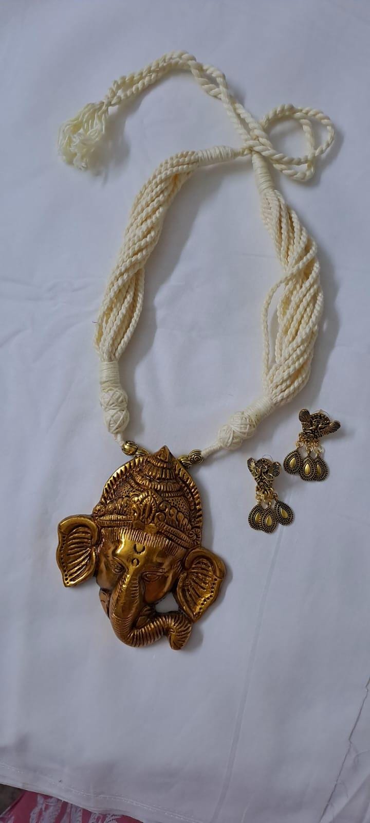 Off-white thread necklace with golden oxidised ganesha pendant