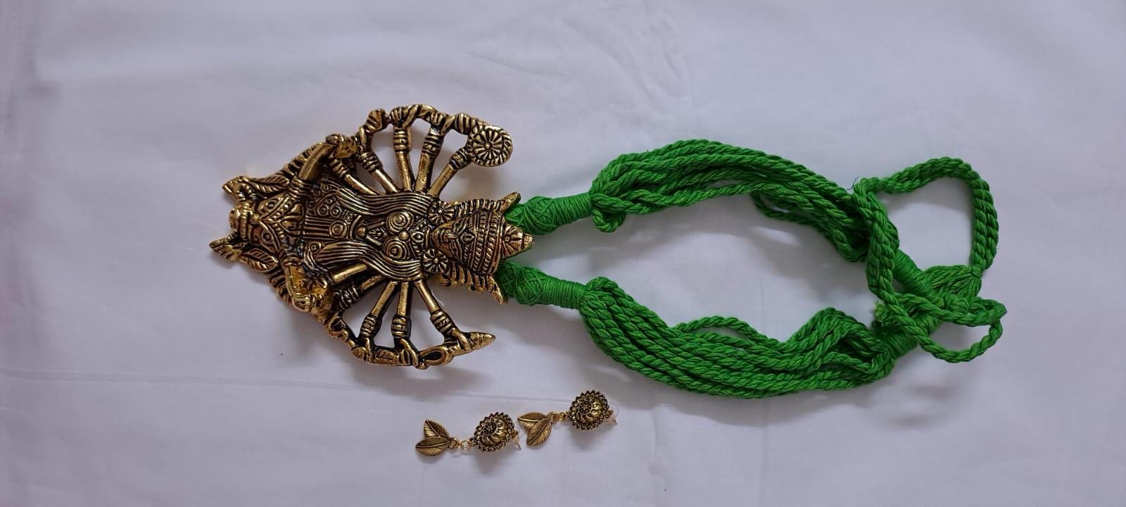 Green thread necklace with oxidised golden durga pendant