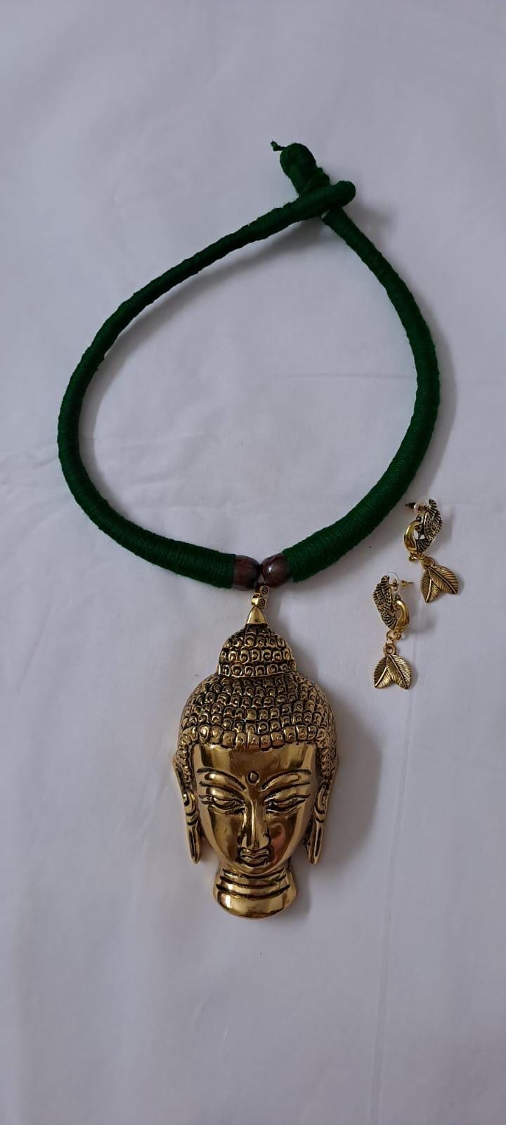 Green thread necklace with oxidised golden buddha pendant