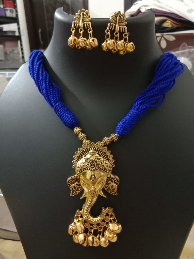 Oxidised golden ganesha traditional pendant and matching earrings.