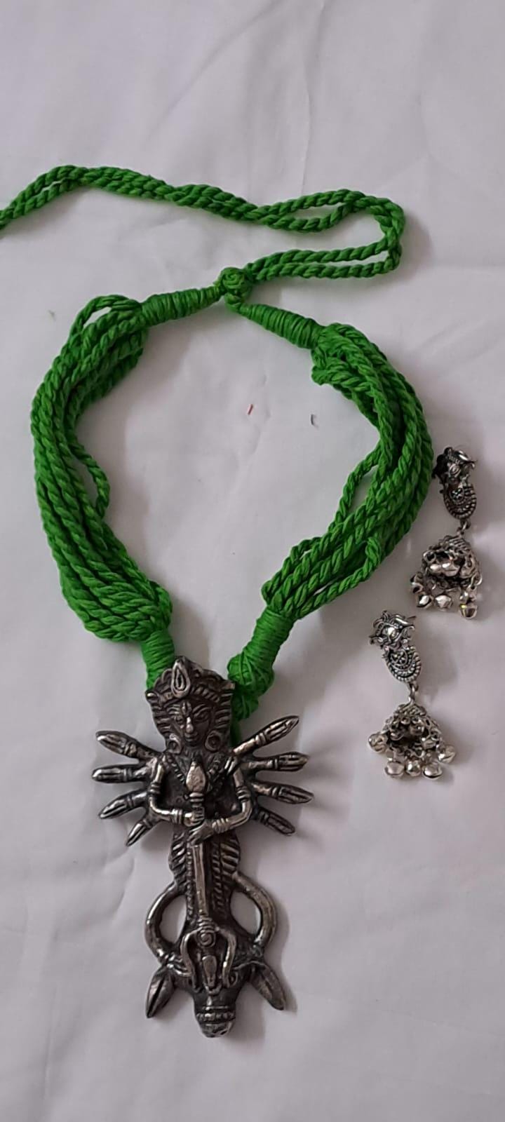 Green thread necklace with oxidised silver durga pendant
