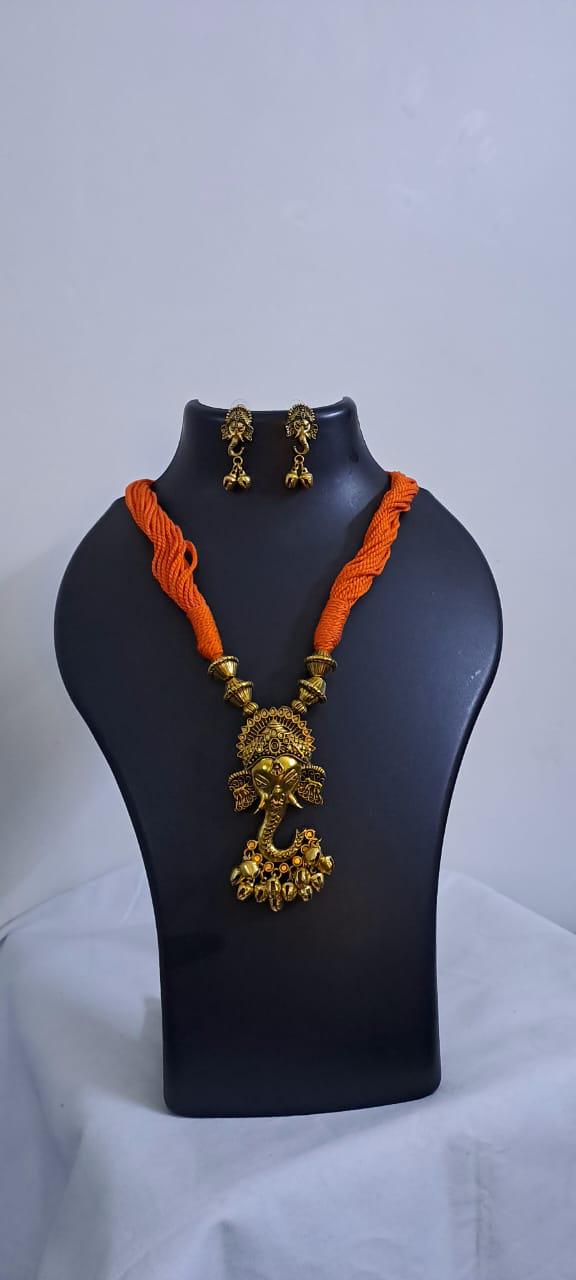 Orange thread necklace with Golden oxidised traditional pendant
