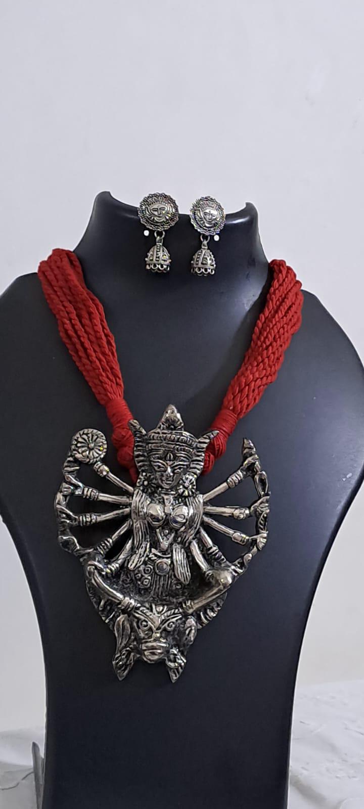 Red thread necklace with oxidised silver durga pendant