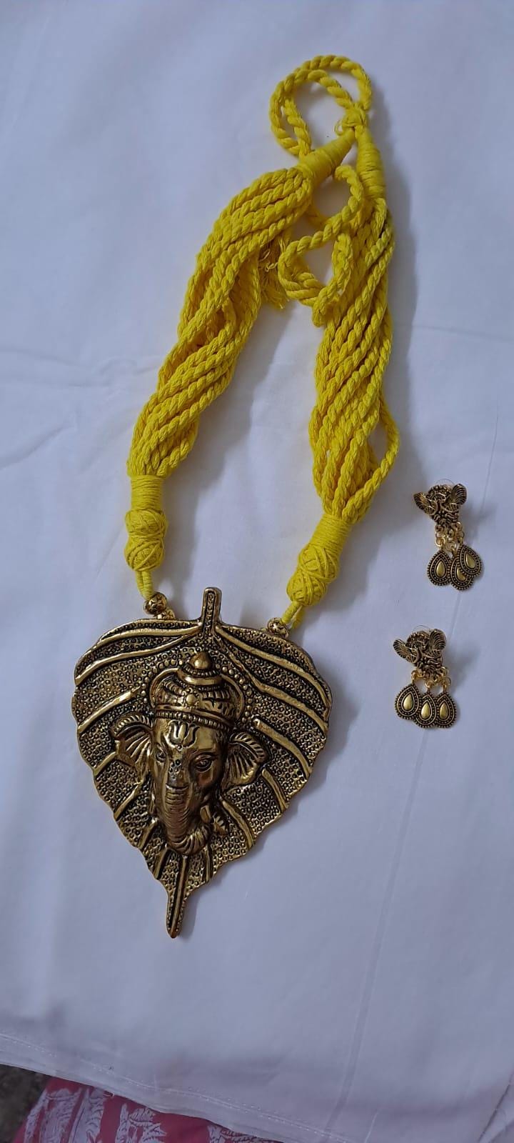 Yellow thread necklace with golden oxidised ganesha pendant