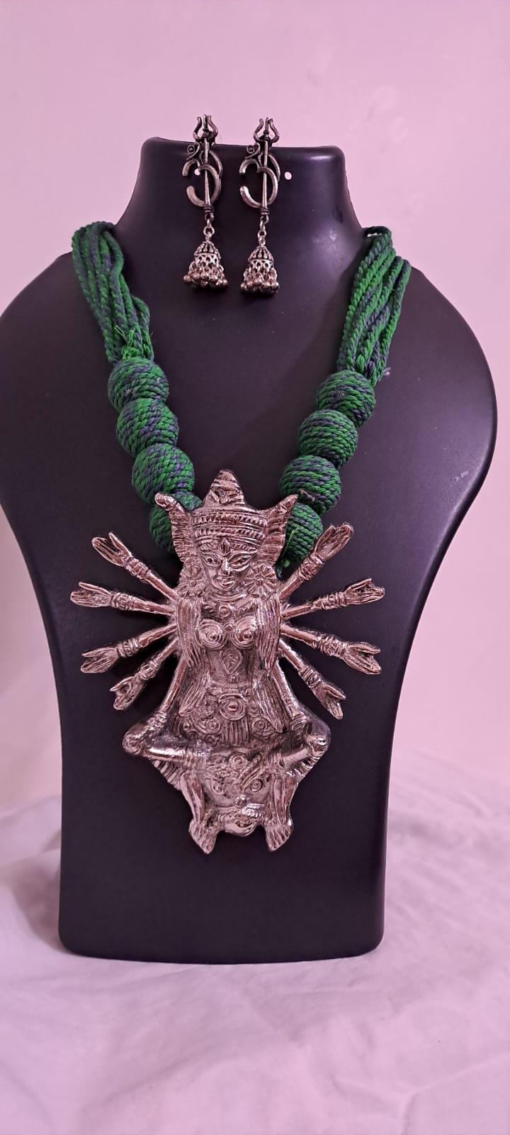 Green thread necklace with oxidised golden durga pendant
