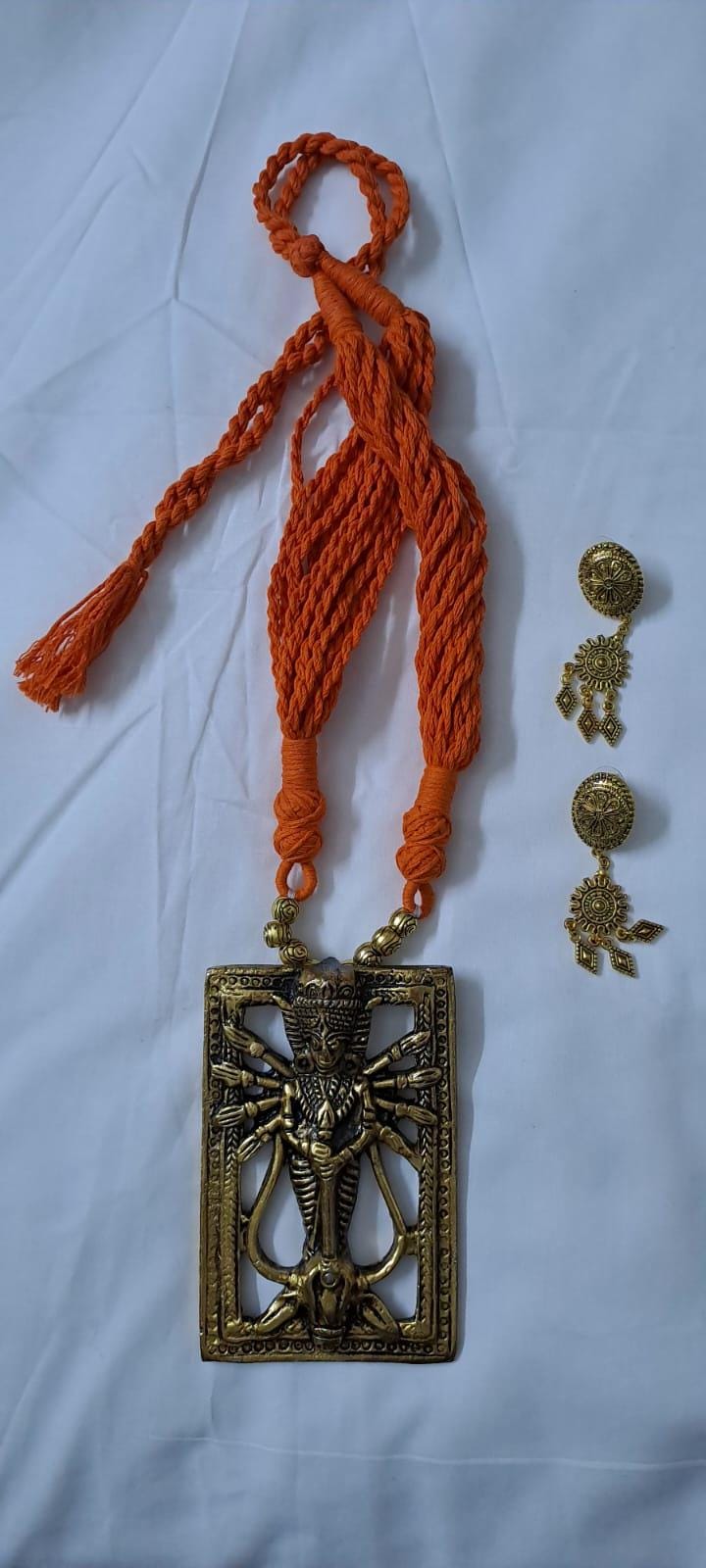 Orange thread necklace with oxidised golden durga pendant