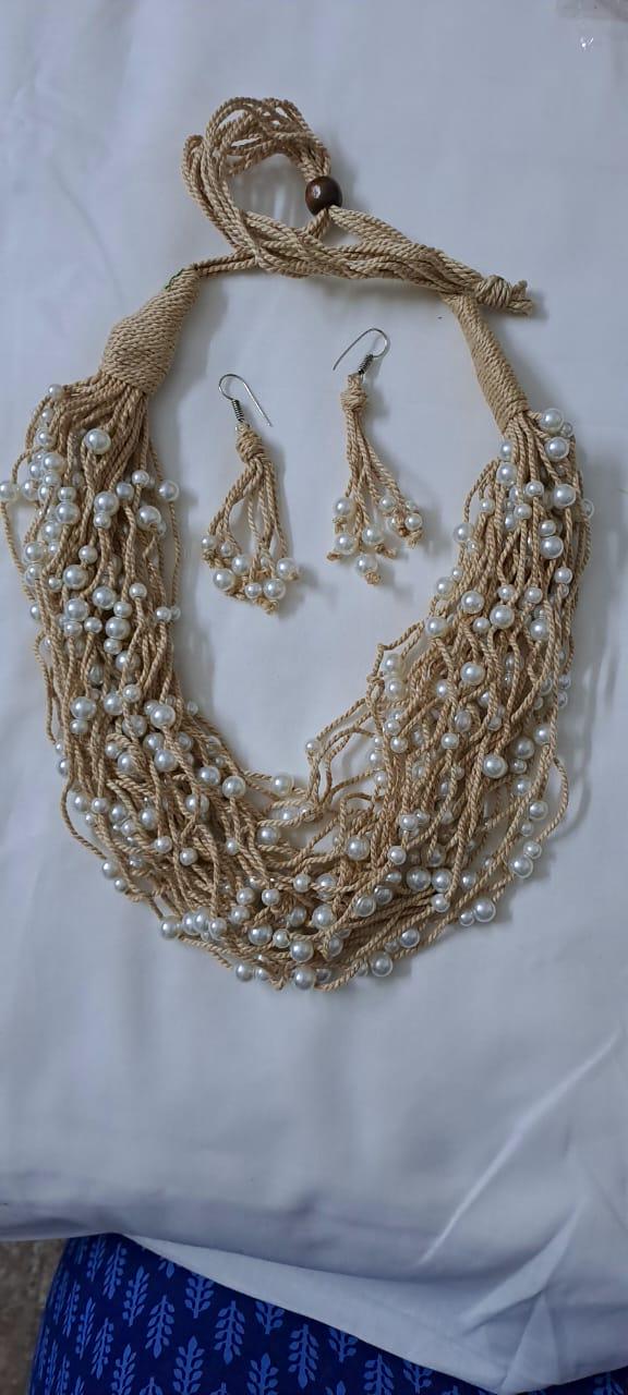 Multi layered jute necklace with pearl beads and with matching earrings.