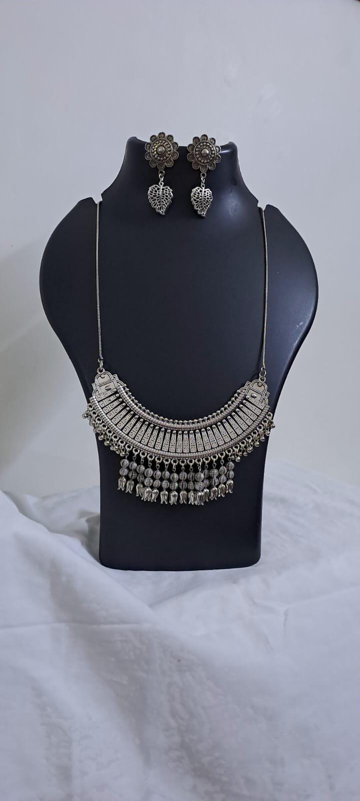 Exclusive necklace with silver oxidised big oval pendant with beads fringes and matching earrings.