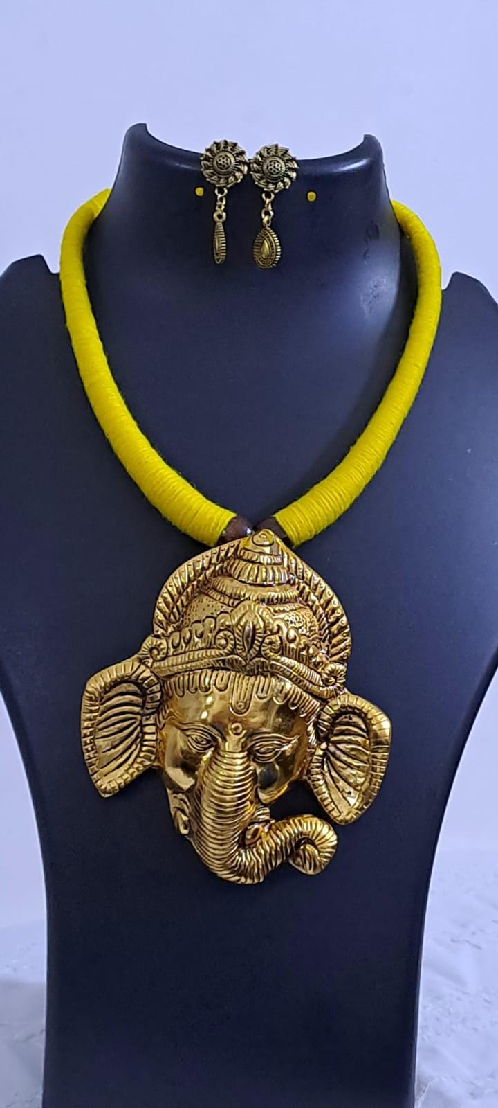Yellow thread necklace with golden oxidised ganesha pendant