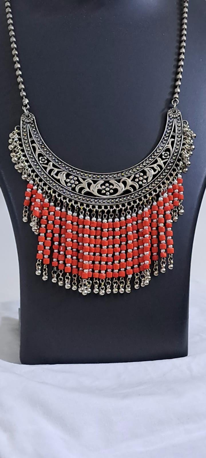 Exclusive necklace with silver oxidised big oval pendant with glass beads fringes and matching earrings.