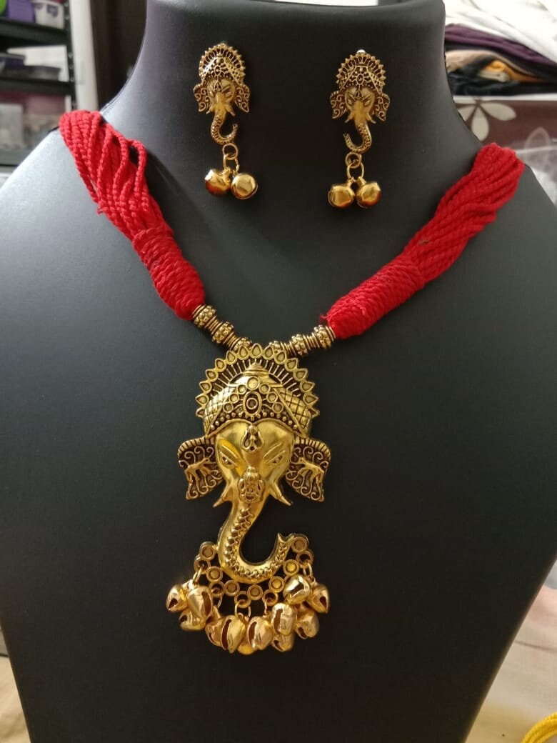 Oxidised golden ganesha traditional pendant and matching earrings.