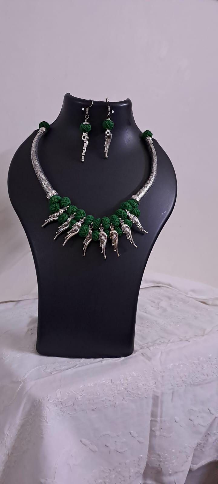Green thread necklace with kolhapuri silver oxidised traditional beads and matching earrings
